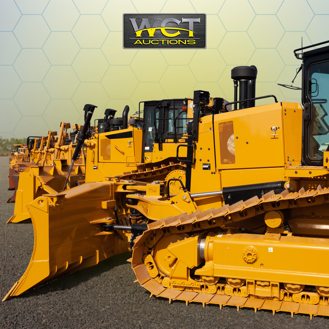Multiple yellow bulldozers parked in a row at an industrial equipment auction yard, branded WCT Auctions, ready for timed online bidding