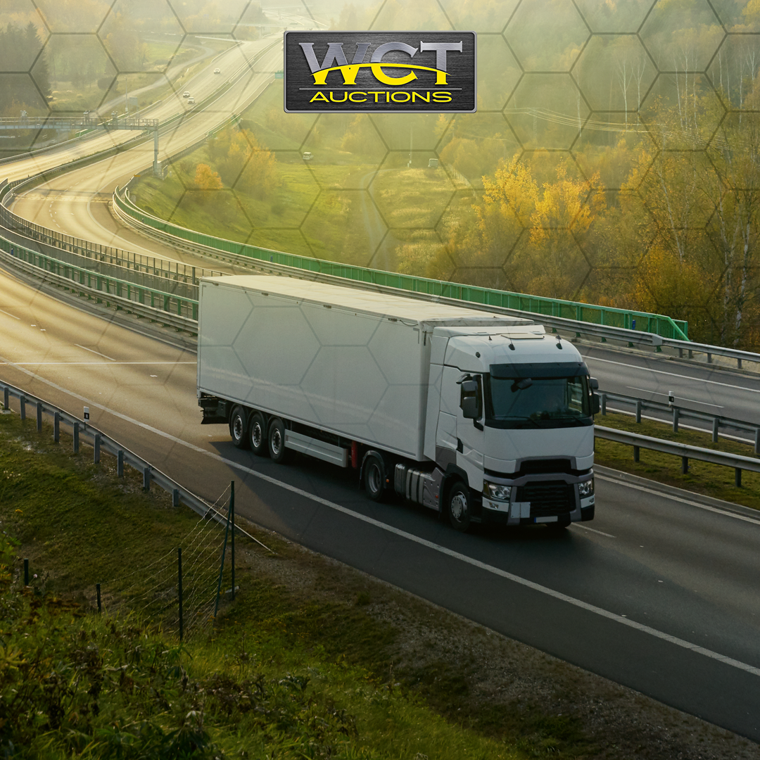 WCT Auctions truck and trailer on highway for fleet asset disposal