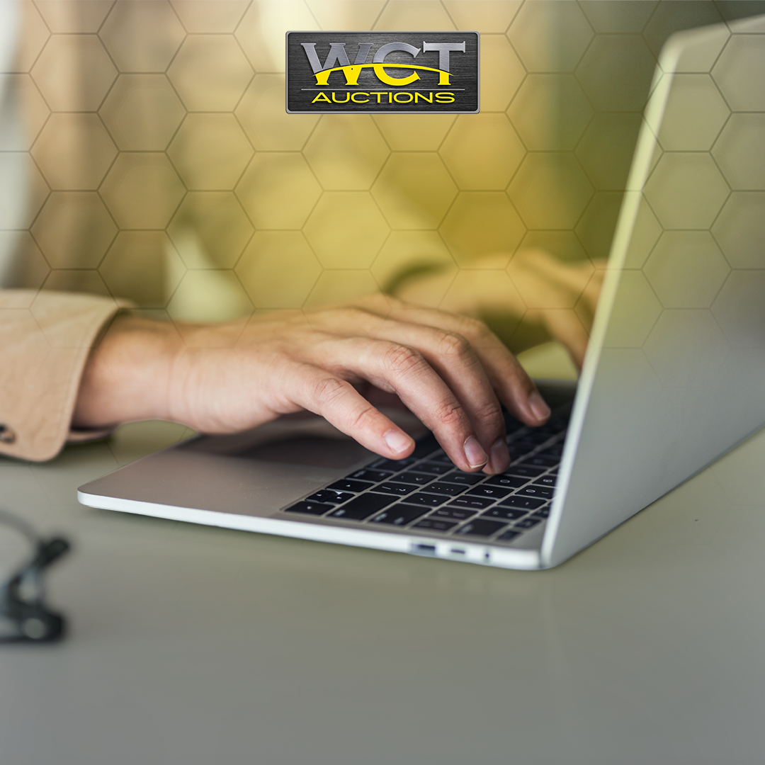 Person using a laptop to browse an online auction