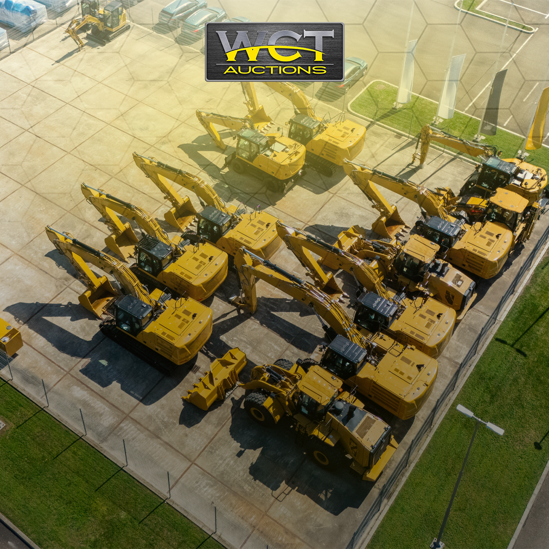 Fleet of yellow excavators and construction equipment arranged in yard for auction disposal by WCT Auctions