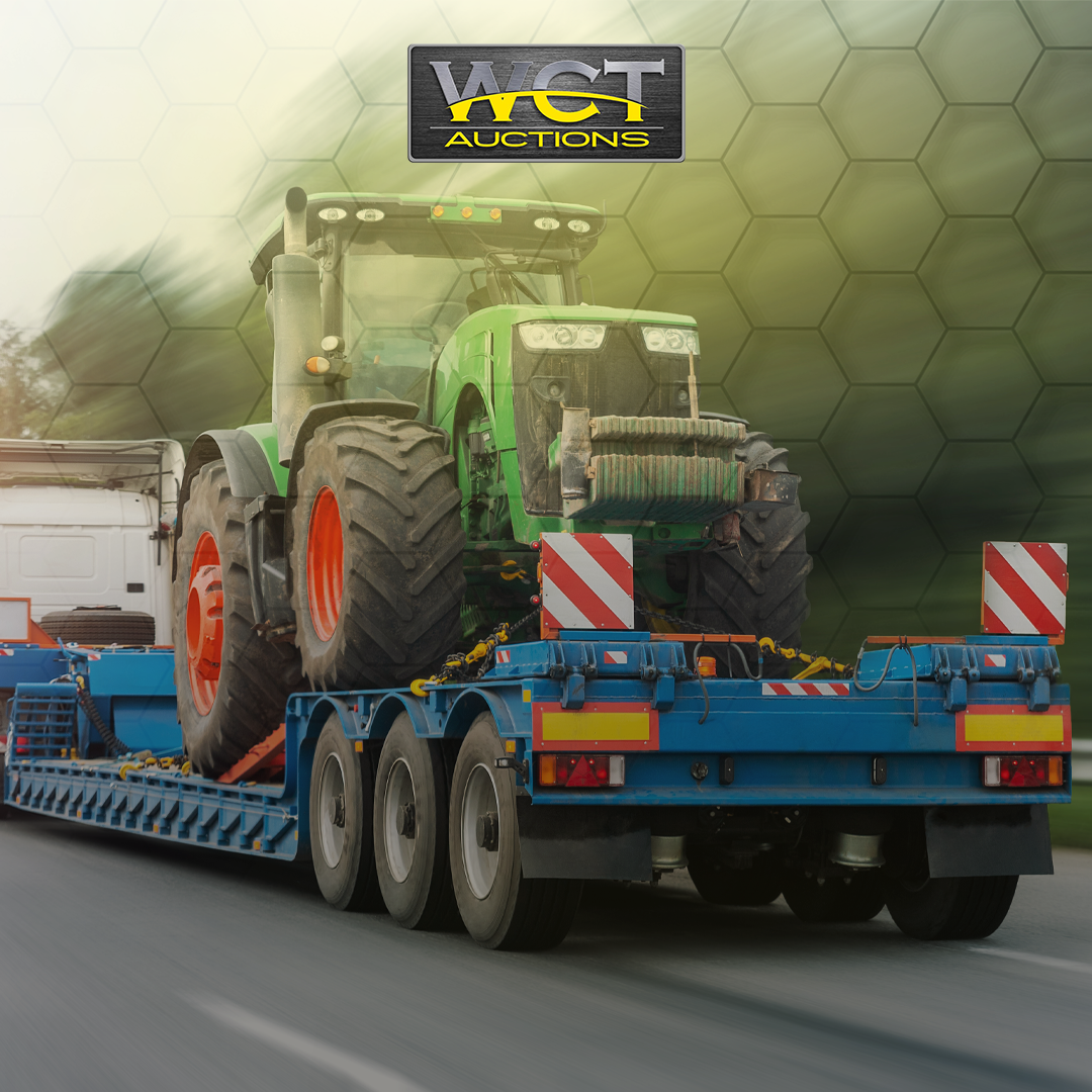 WCT Auctions lowbed trailer transporting tractor equipment